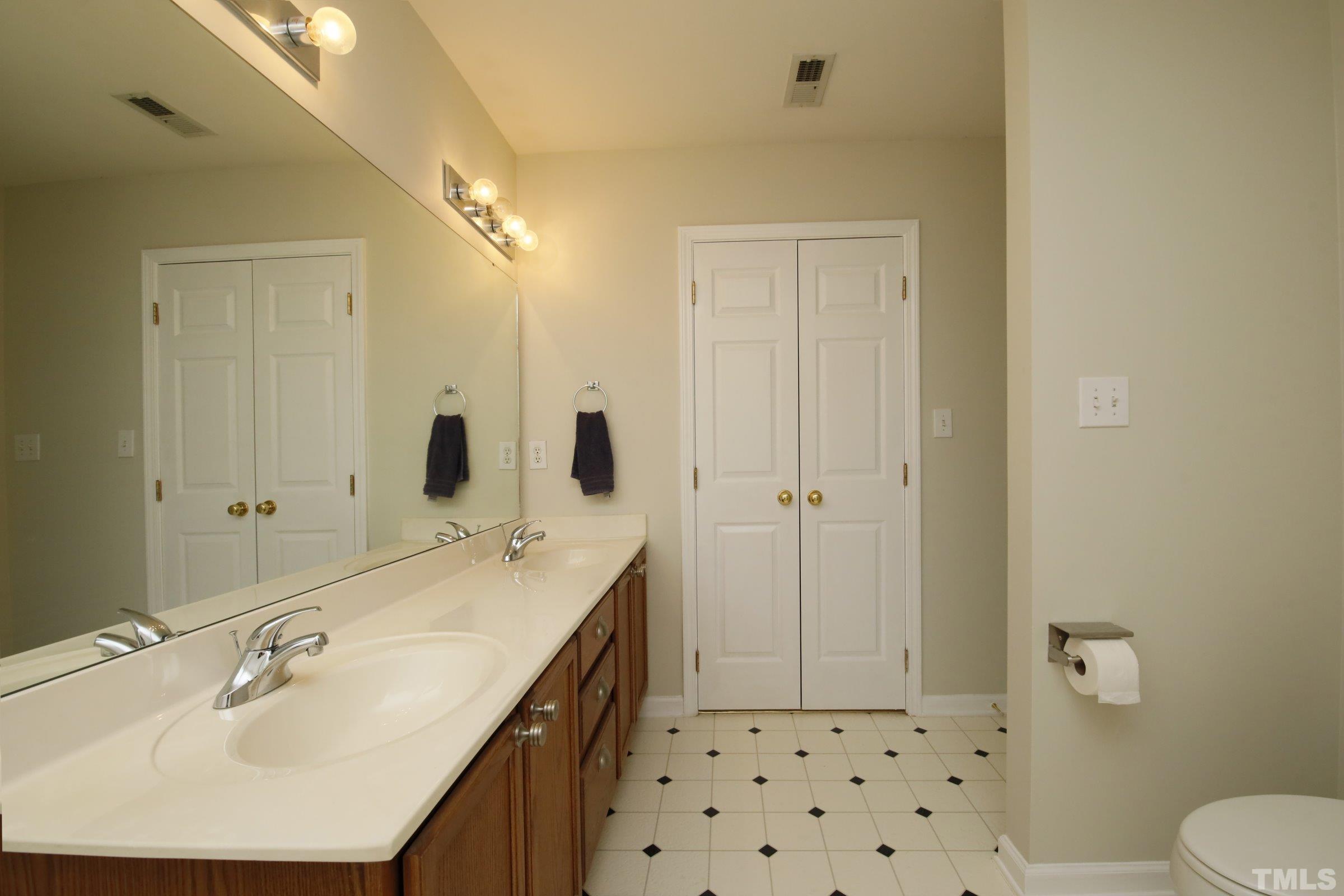 5633 Slide Rock Lane Raleigh, NC 27613 - Photo 22 of 32 a bathroom with a sink a toilet and shower