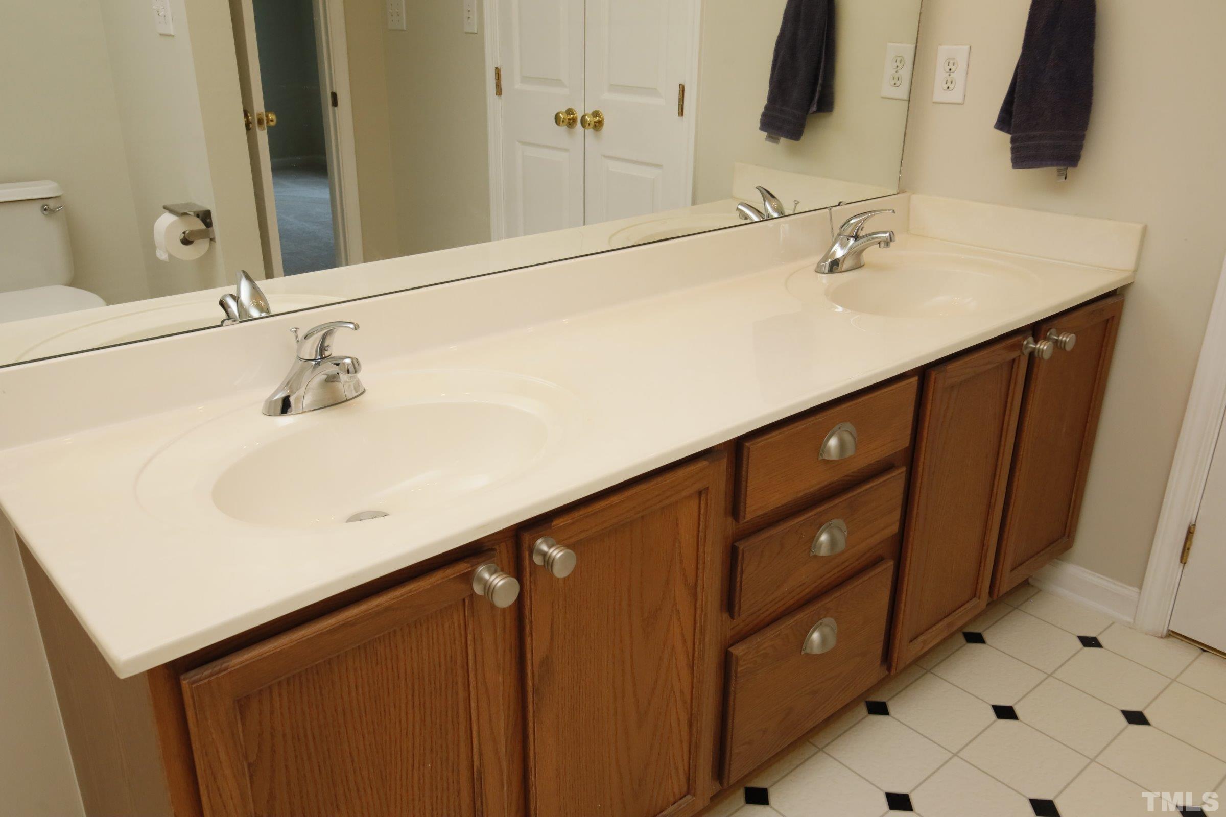 5633 Slide Rock Lane Raleigh, NC 27613 - Photo 23 of 32 a bathroom with a sink and a mirror