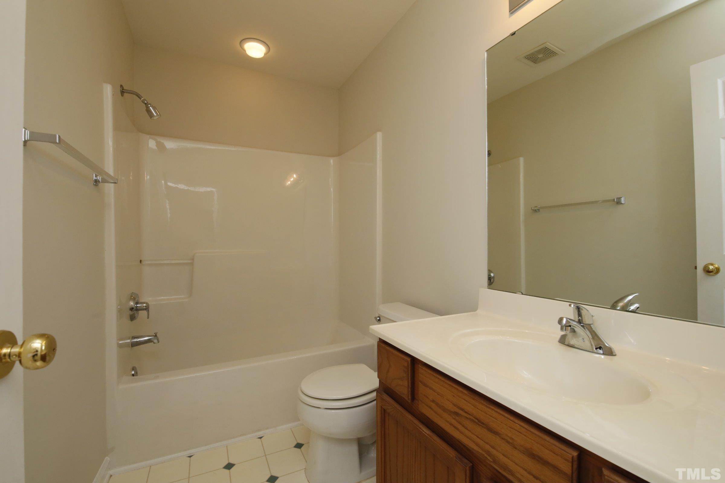 5633 Slide Rock Lane Raleigh, NC 27613 - Photo 26 of 32 a bathroom with a sink a toilet and shower