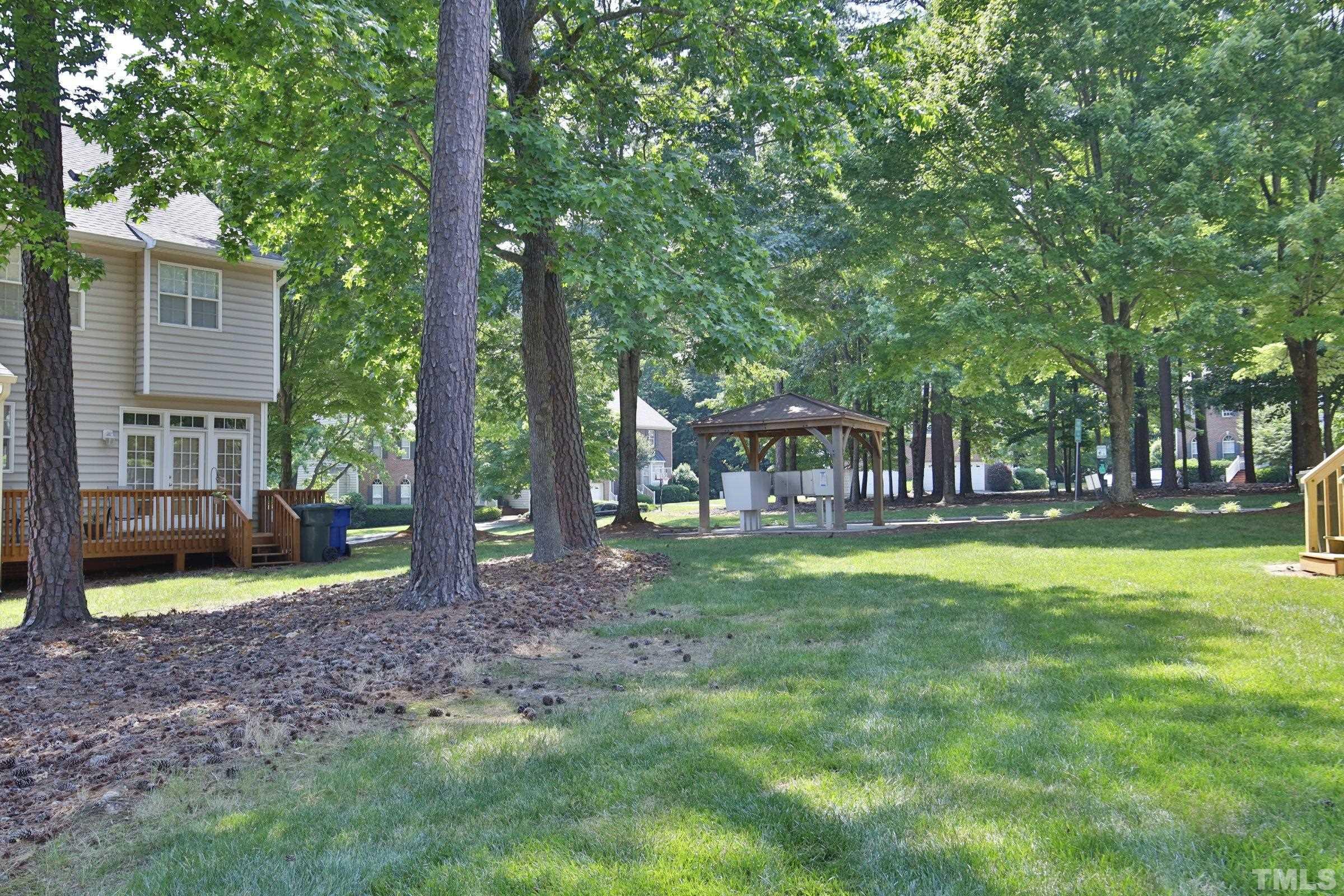 5633 Slide Rock Lane Raleigh, NC 27613 - Photo 29 of 32 a view of a house with backyard and a tree