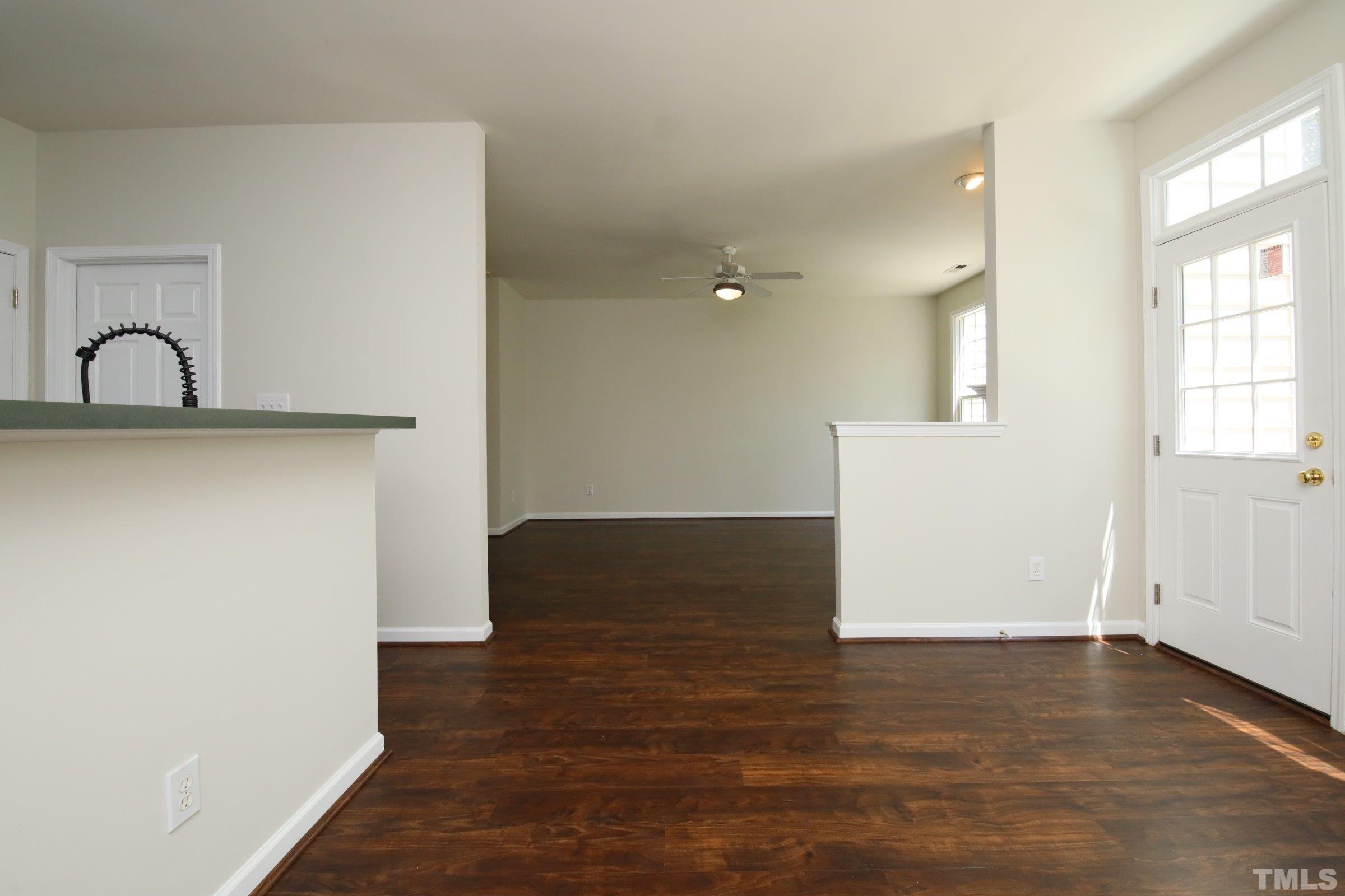 5633 Slide Rock Lane Raleigh, NC 27613 - Photo 8 of 32 a view of an empty room with wooden floor and a window