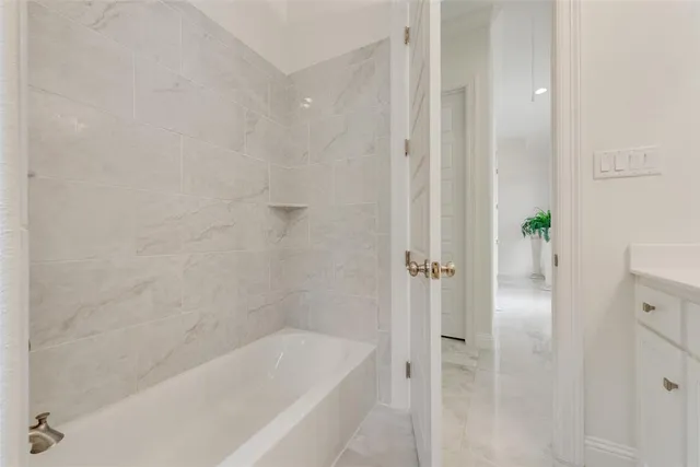 a bathroom with a bathtub and a shower