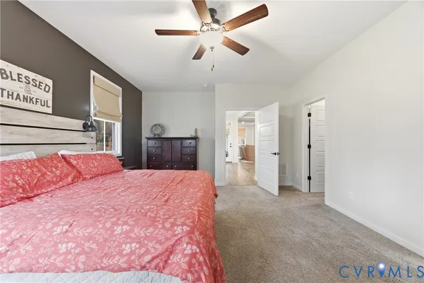 a spacious bedroom with a bed and a chandelier