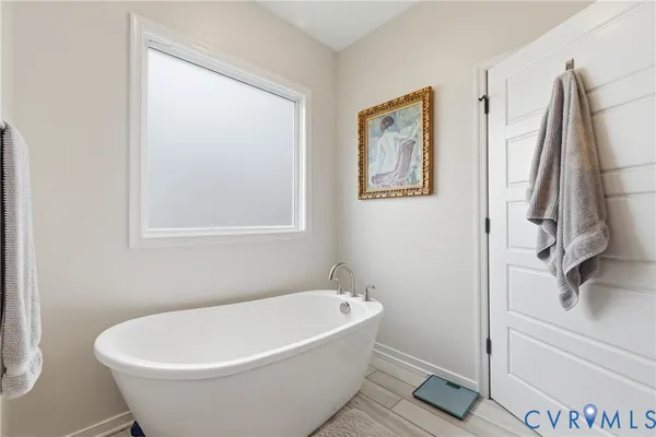 a white bath tub sitting next to a white sink