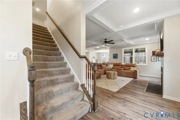 a view of entryway and hall with wooden floor