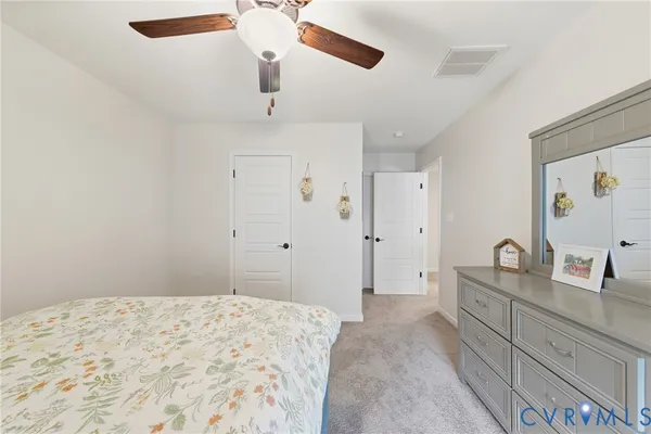 a bedroom with a large bed and chandelier