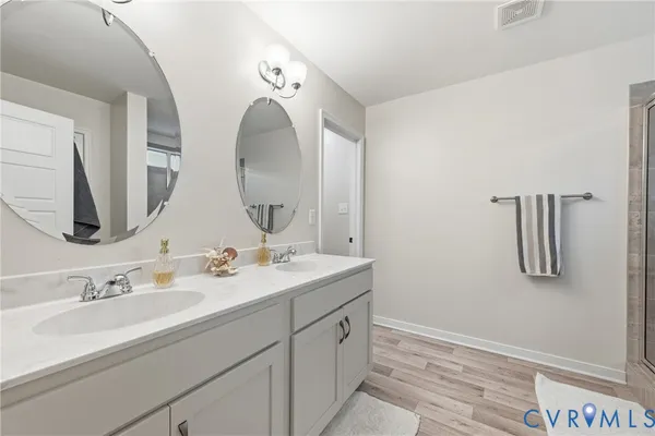 a bathroom with a double vanity sink and a mirror