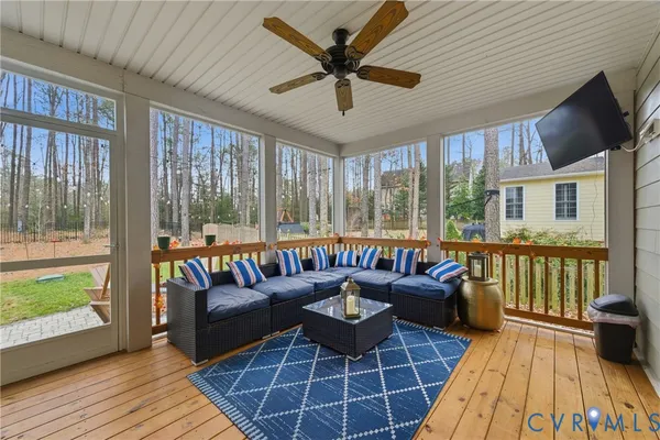 a living room with furniture and a floor to ceiling window