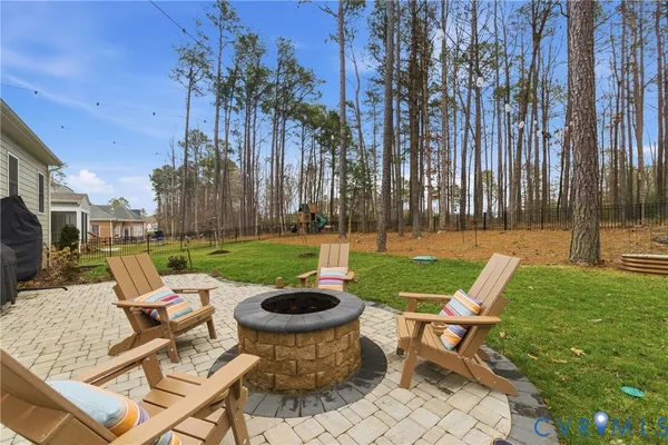 a view of a patio with table and chairs potted plants and palm trees