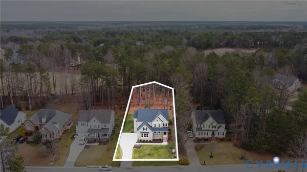 an aerial view of a house with a yard
