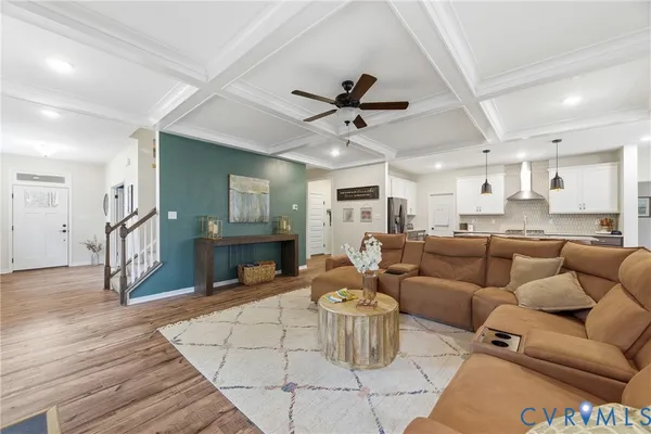 a living room with furniture and kitchen view