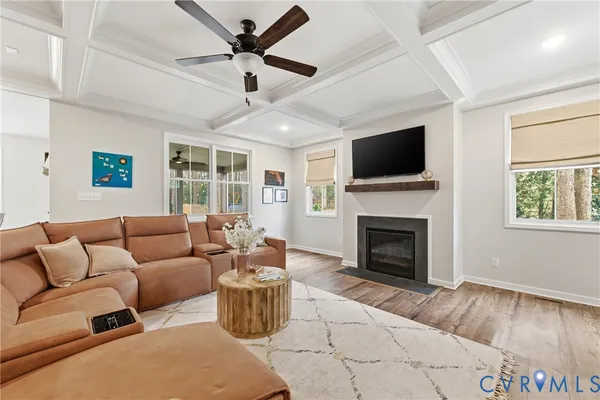 a living room with furniture a fireplace and a flat screen tv
