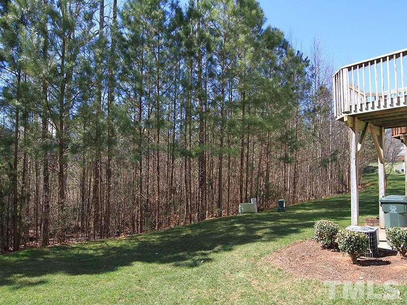 8449 Reedy Ridge Lane Raleigh, NC 27613 - Photo 12 of 12 a backyard of a house with lots of green space
