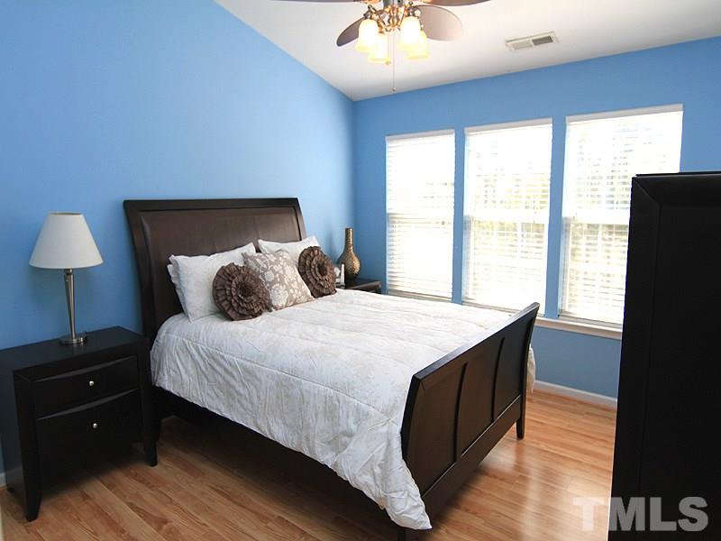 8449 Reedy Ridge Lane Raleigh, NC 27613 - Photo 7 of 12 a bedroom with a bed and a window