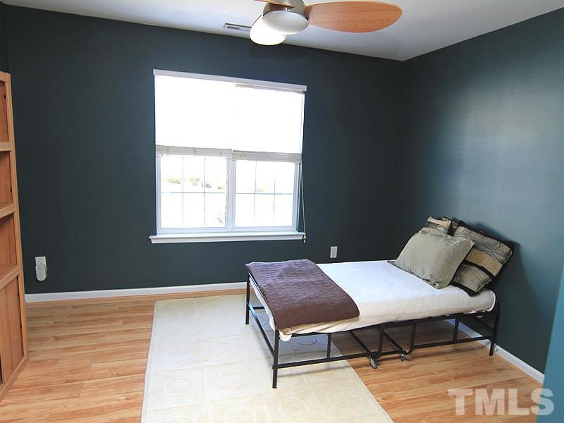 8449 Reedy Ridge Lane Raleigh, NC 27613 - Photo 9 of 12 a bedroom with a bed and window
