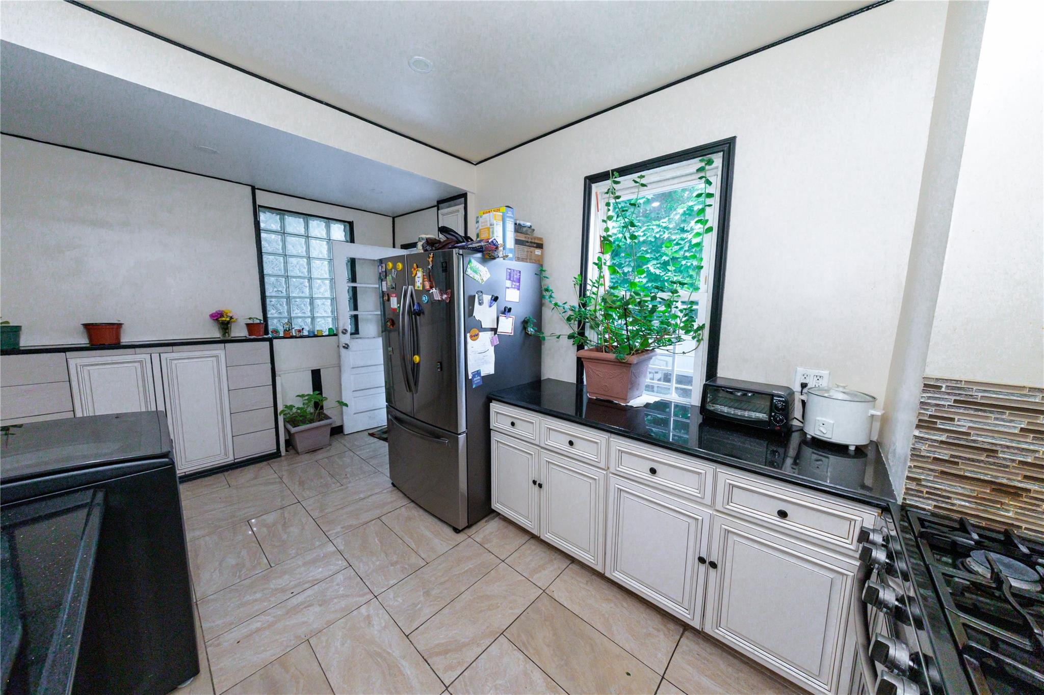 85-21 80th Street Queens, NY 11421 - Photo 15 of 39 a kitchen with a sink appliances and cabinets