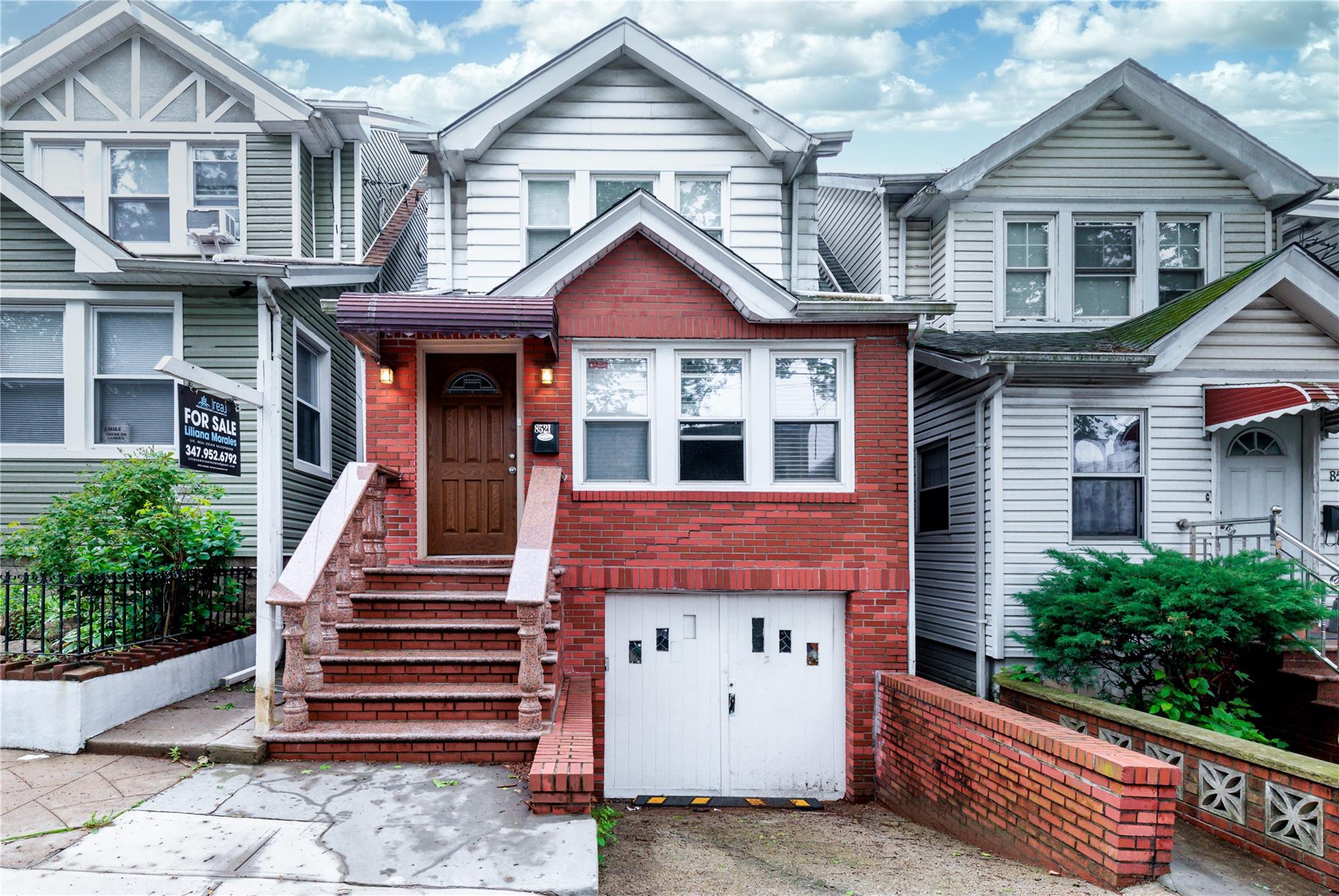 85-21 80th Street Queens, NY 11421 - Photo 2 of 39 a front view of a house with a yard