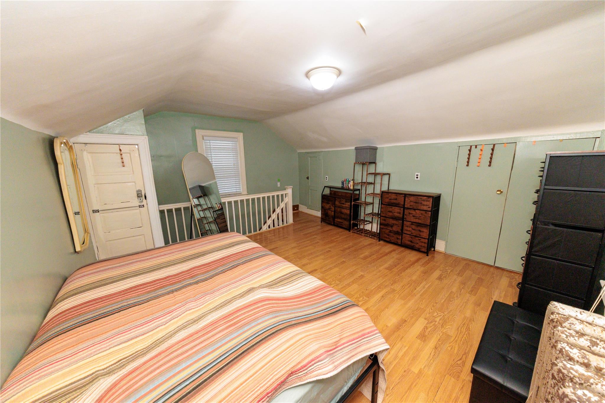 85-21 80th Street Queens, NY 11421 - Photo 25 of 39 a bedroom with a bed and a dresser in it