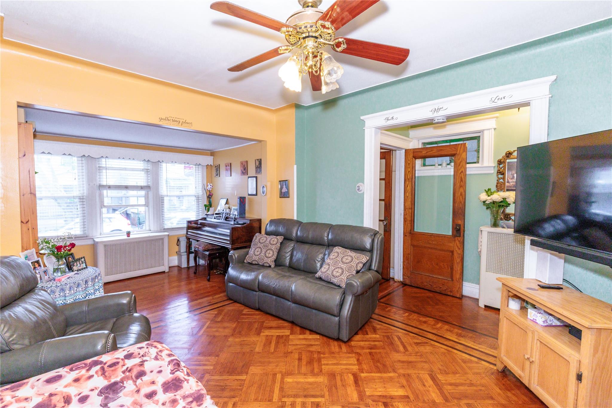 85-21 80th Street Queens, NY 11421 - Photo 3 of 39 a living room with furniture and a flat screen tv
