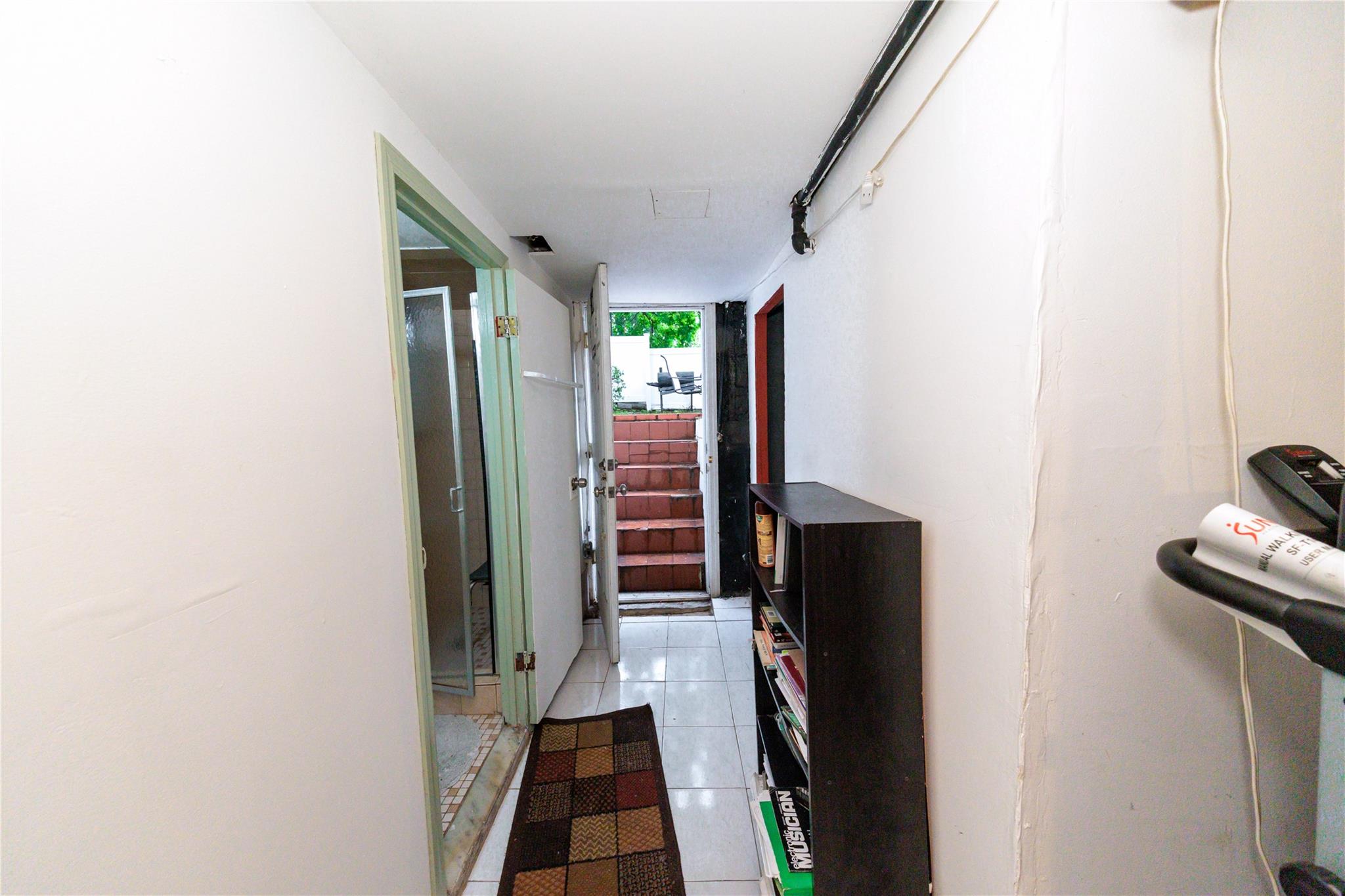 85-21 80th Street Queens, NY 11421 - Photo 32 of 39 a view of a hallway with wooden floor and staircase