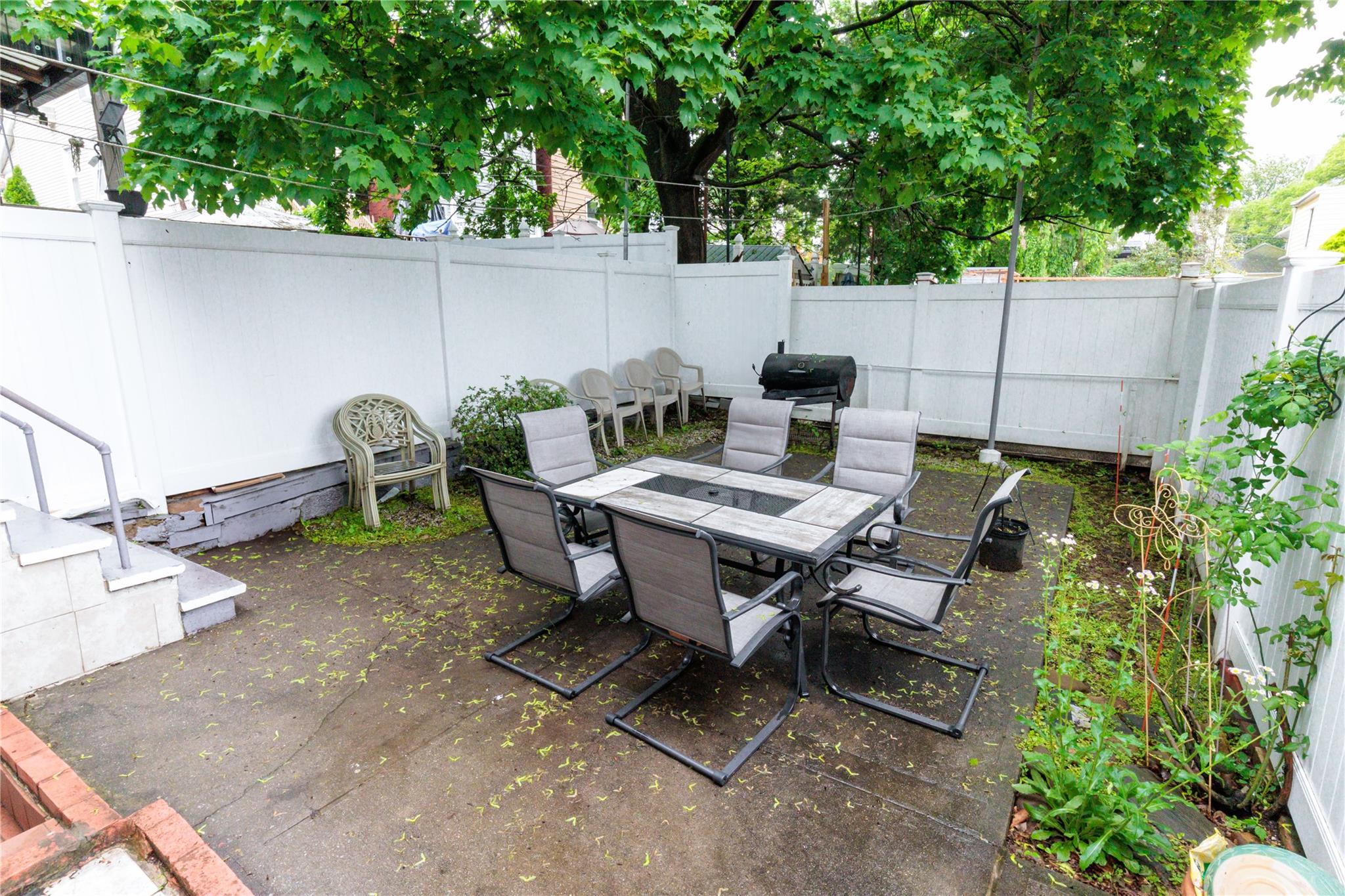 85-21 80th Street Queens, NY 11421 - Photo 36 of 39 a backyard of a house with outdoor seating