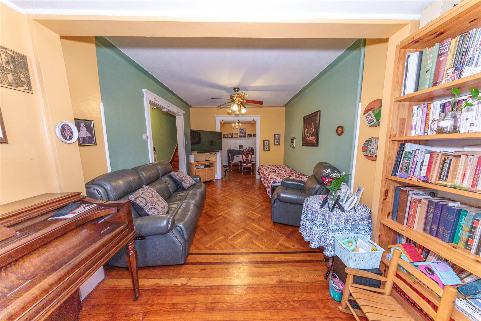 85-21 80th Street Queens, NY 11421 - Photo 4 of 39 a living room with fireplace furniture and a book shelf