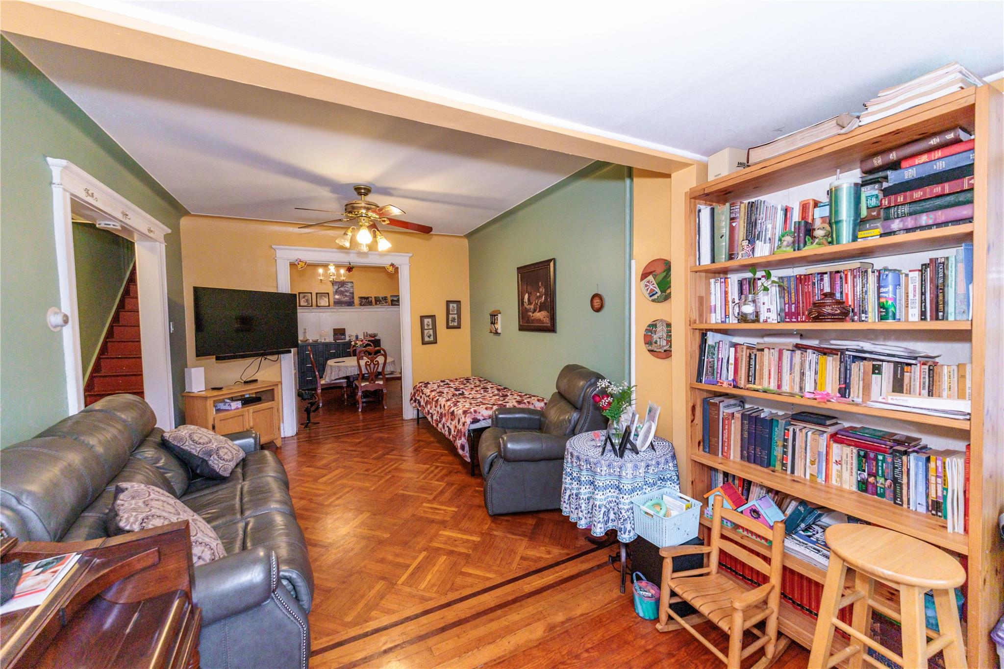 85-21 80th Street Queens, NY 11421 - Photo 5 of 39 a living room with furniture and a book shelf