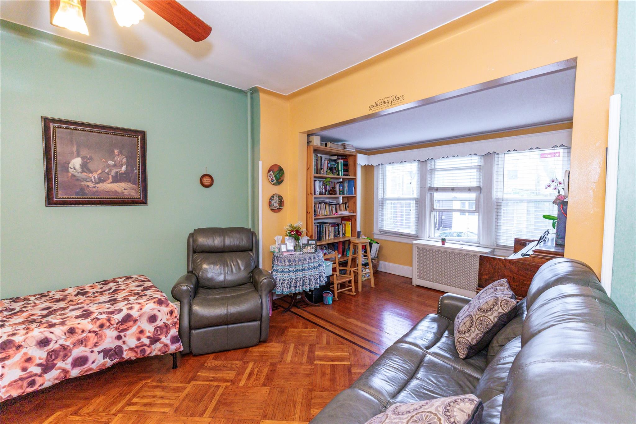 85-21 80th Street Queens, NY 11421 - Photo 9 of 39 a living room with furniture and a large window
