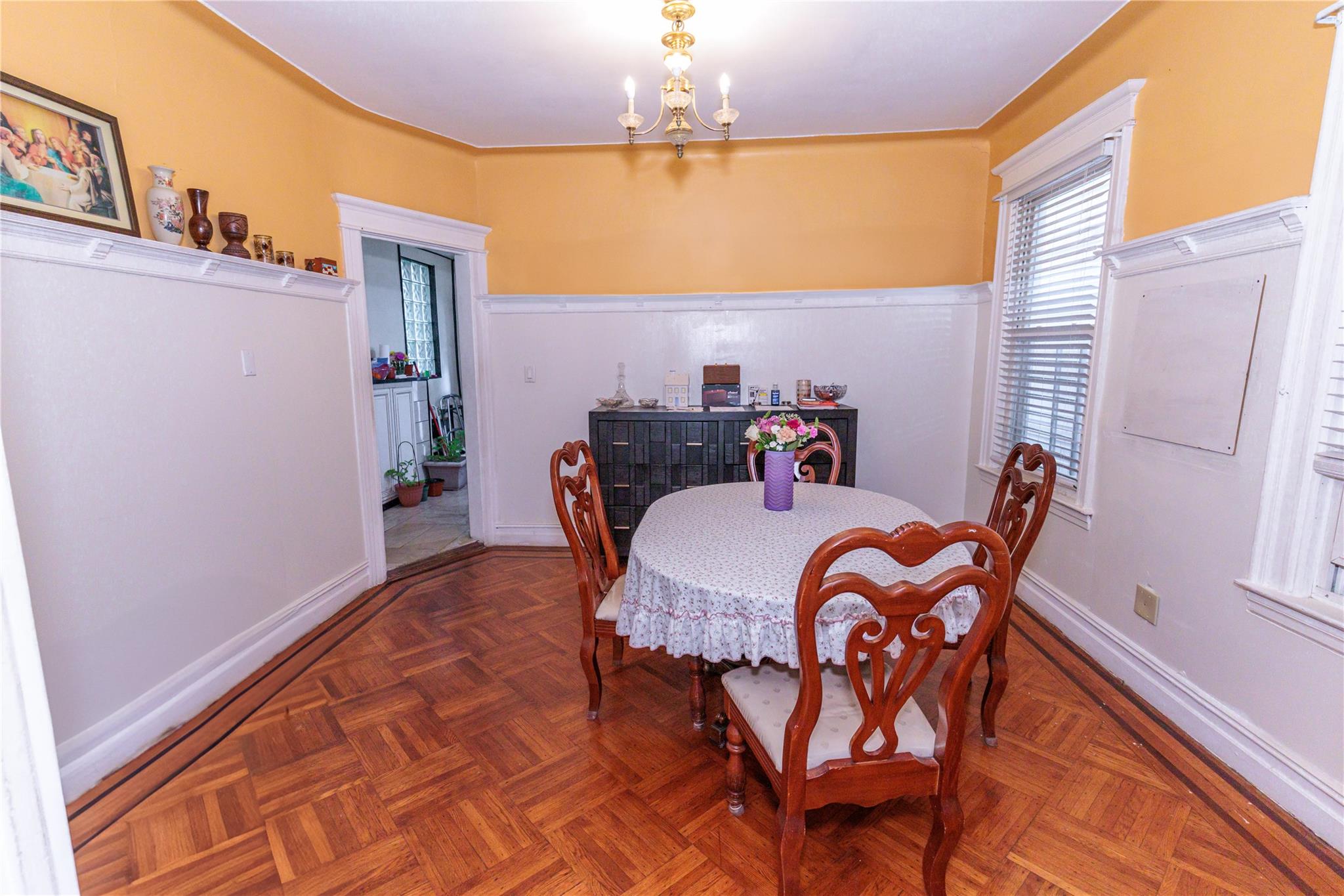 85-21 80th Street Queens, NY 11421 - Photo 10 of 39 a dining room with furniture and chandelier