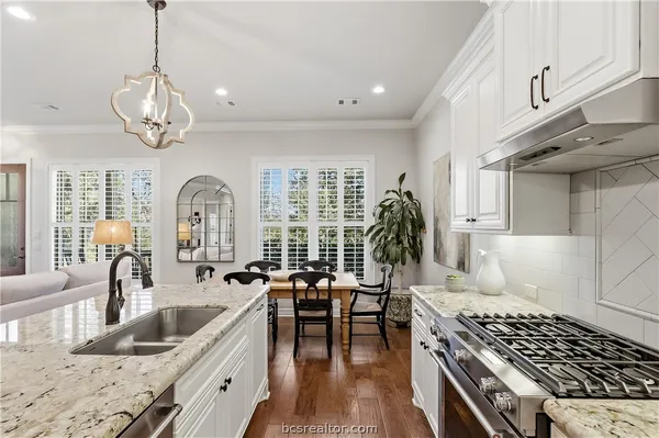 a kitchen with sink stove and cabinets