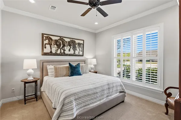 a bedroom with a large bed and a window