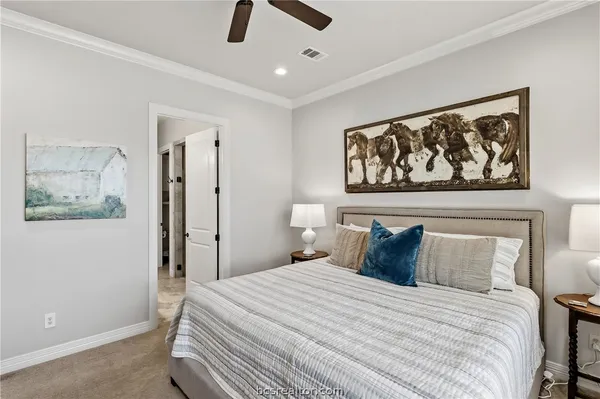 a bedroom with a bed and a painting on the wall