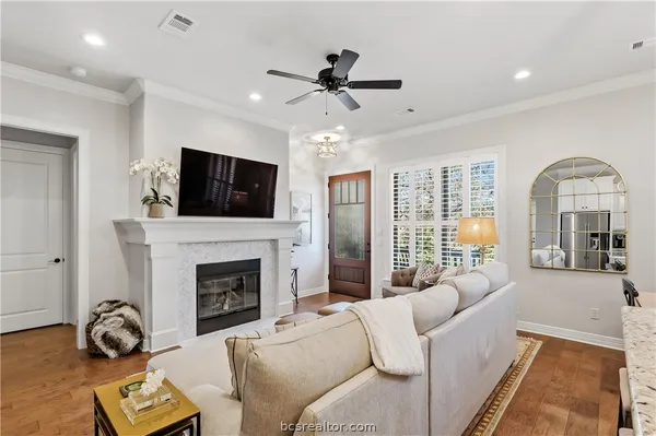 a living room with furniture a fireplace and a flat screen tv