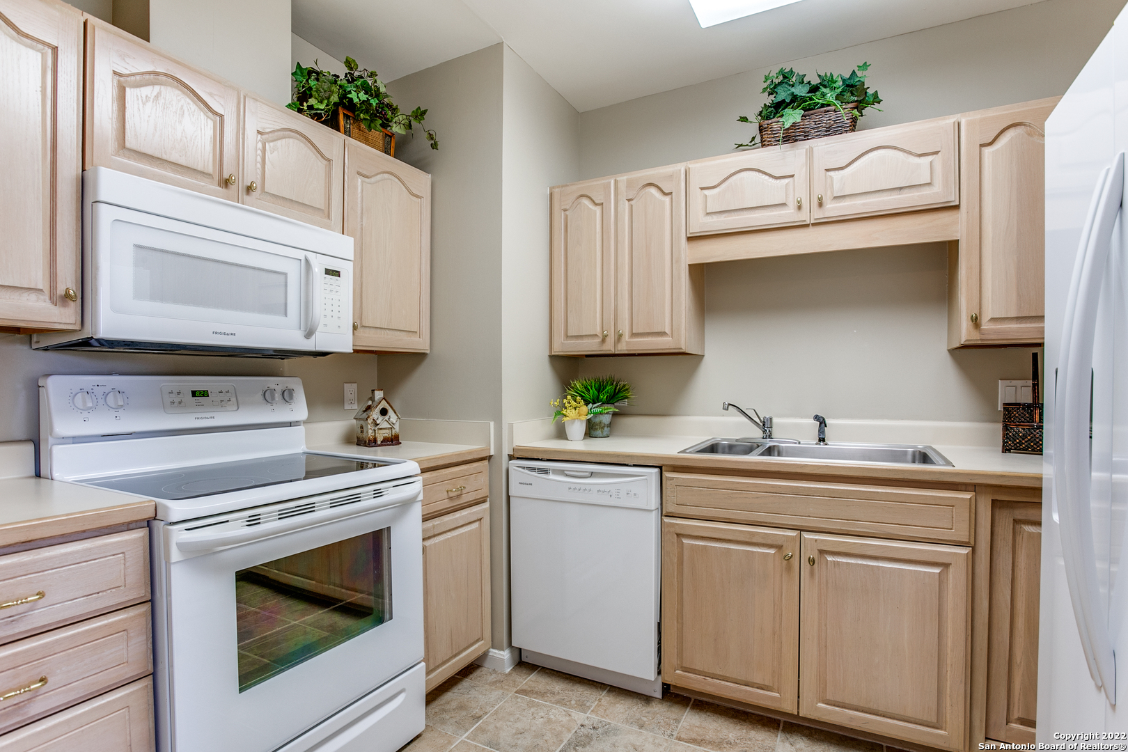 a kitchen with cabinets stainless steel appliances and a stove