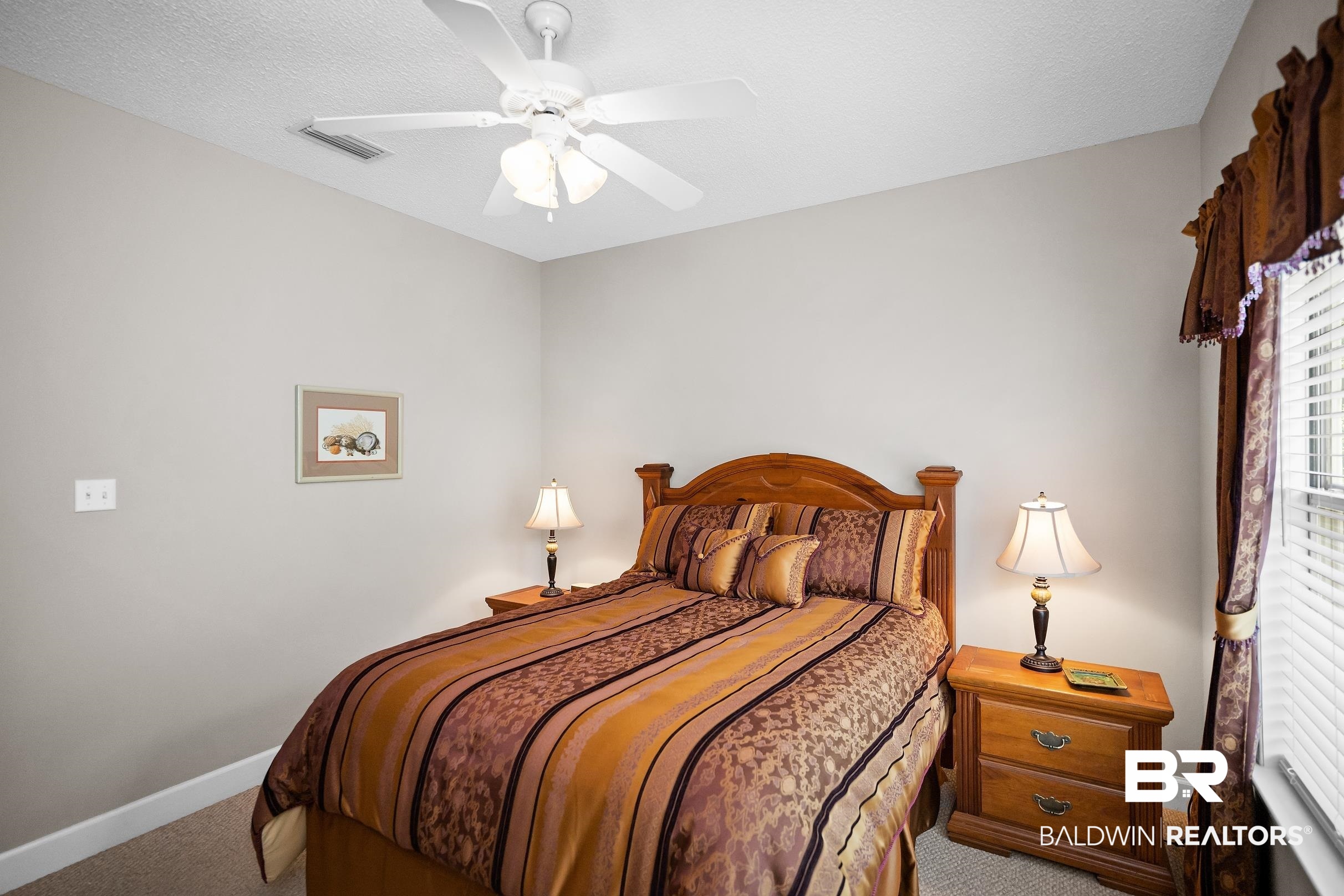 430 West Fort Morgan Road, Unit 704 Gulf Shores, AL 36542 - Photo 17 of 35 Carpeted bedroom featuring a ceiling fan with integrated lighting, a window with blinds and valance, and neutral wall tones