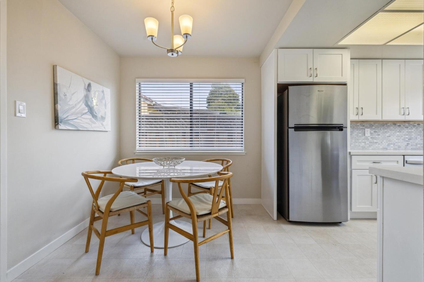 225 Arundel Road Burlingame, CA 94010 - Photo 26 of 58 a kitchen with stainless steel appliances granite countertop a table chairs and a refrigerator