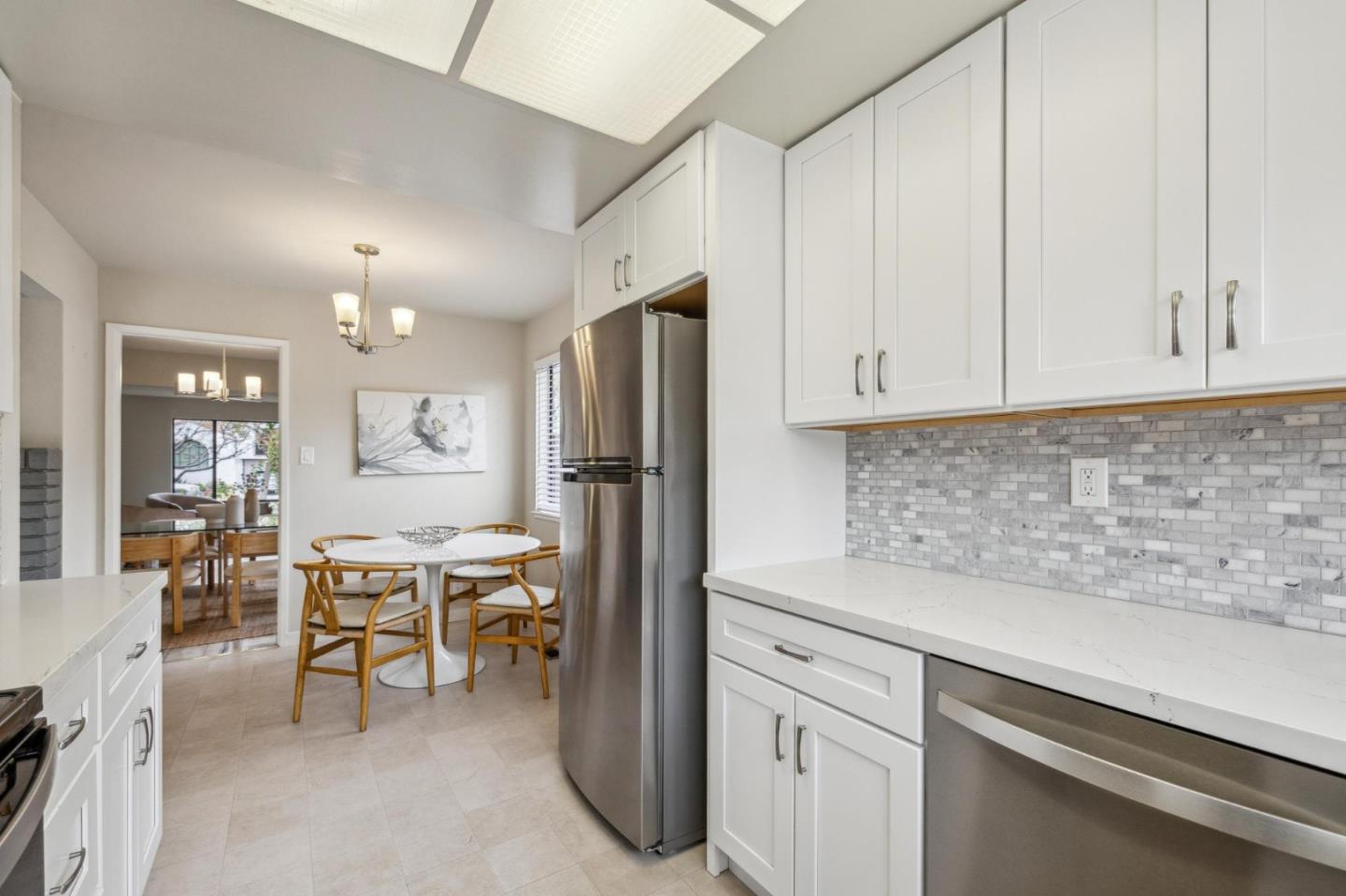 225 Arundel Road Burlingame, CA 94010 - Photo 31 of 58 a kitchen with stainless steel appliances granite countertop a refrigerator sink and white cabinets
