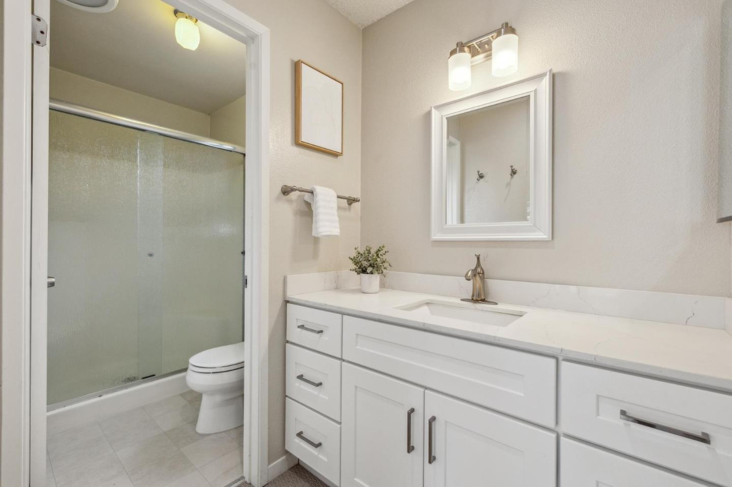 225 Arundel Road Burlingame, CA 94010 - Photo 47 of 58 a bathroom with a granite countertop sink a toilet and a mirror