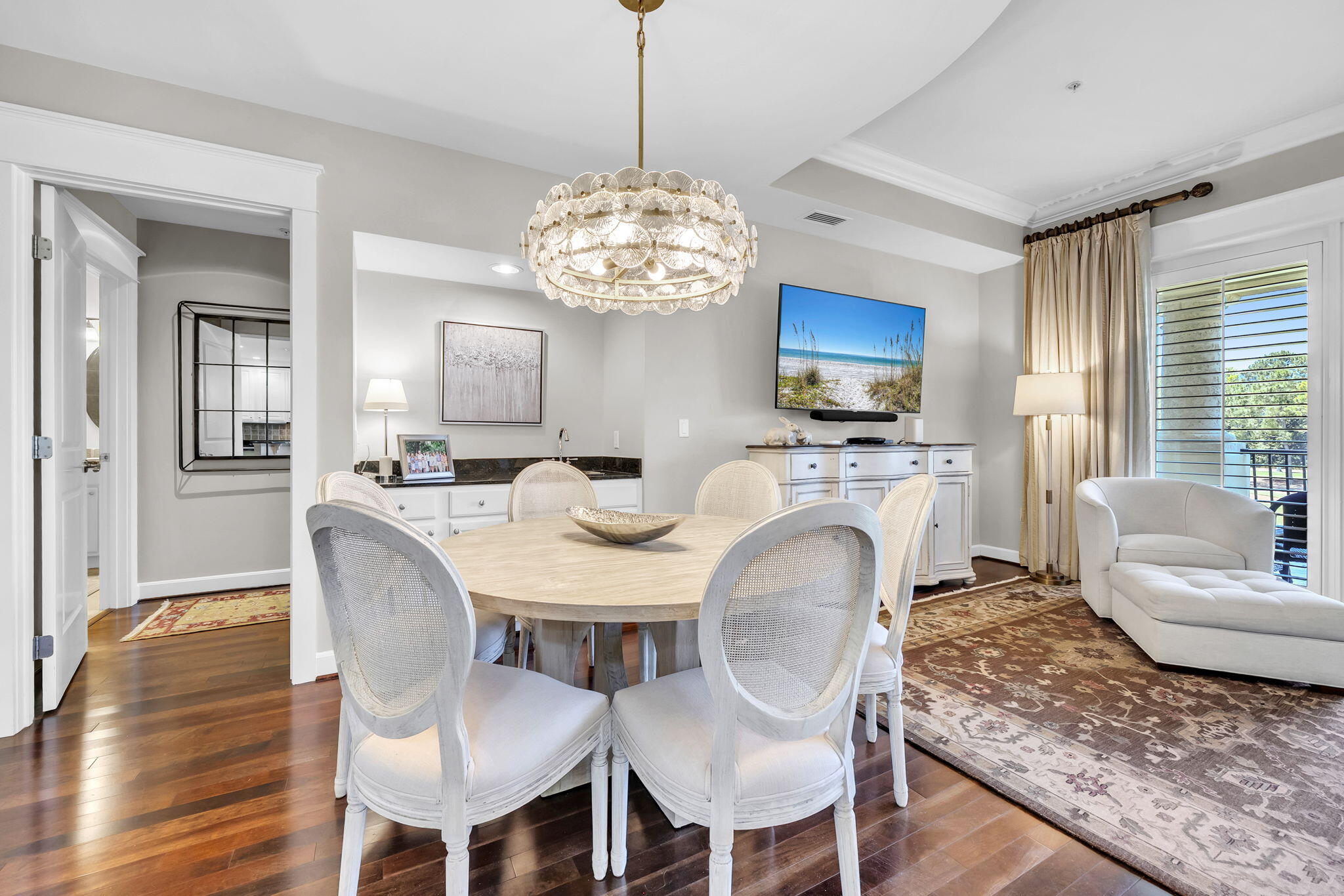 5360 Pine Ridge Lane, Unit 5360 Miramar Beach, FL 32550 - Photo 12 of 44 a view of a dining room with furniture a chandelier and wooden floor