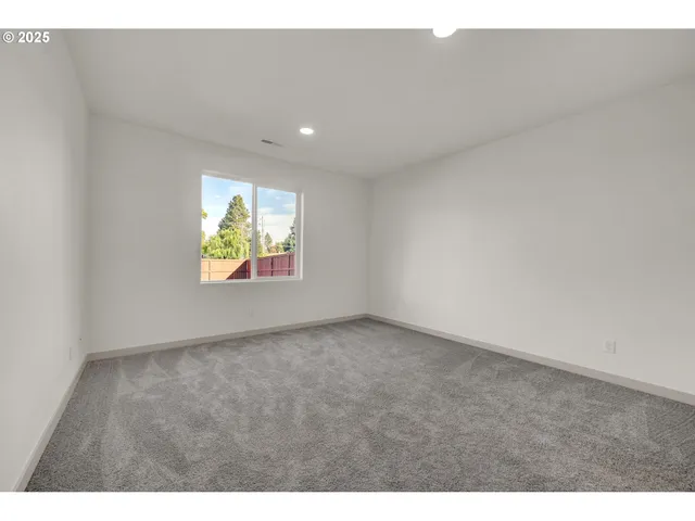 a view of an empty room and a window