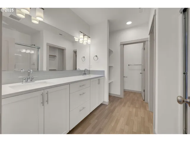 a spacious bathroom with a granite countertop sink mirror and a