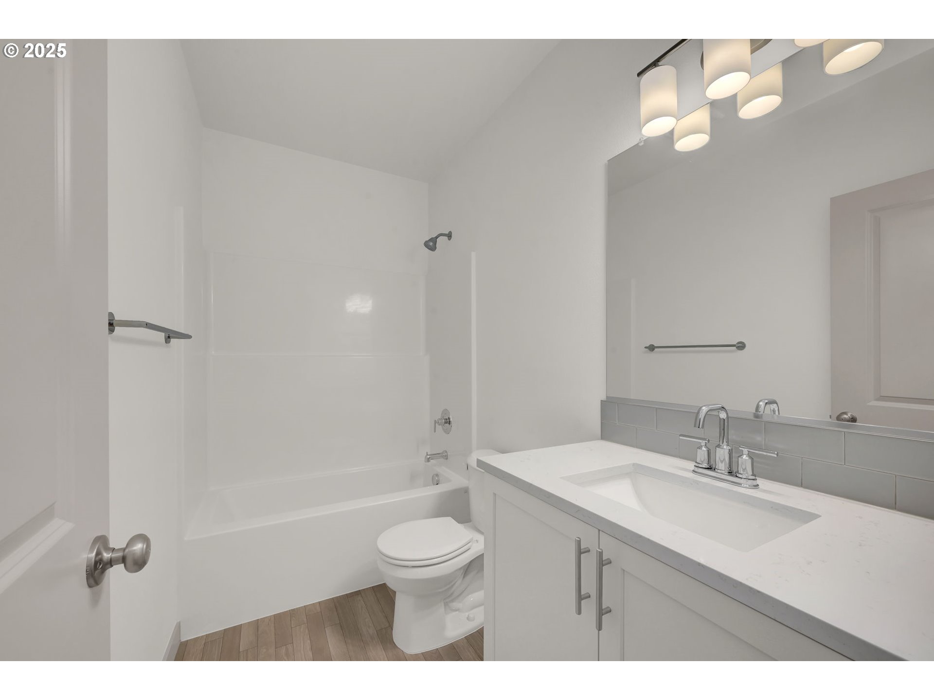 5645 Magnificence Way Eugene, OR 97402 - Photo 25 of 38 a bathroom with a granite countertop sink a toilet and shower