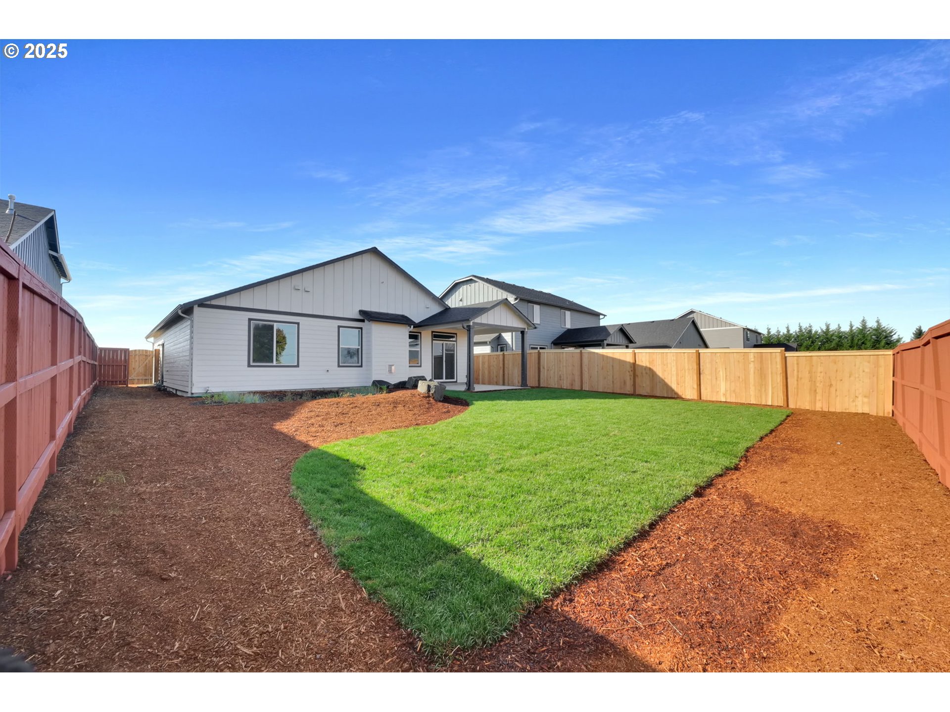 5645 Magnificence Way Eugene, OR 97402 - Photo 29 of 38 a front view of a house with a yard and garage