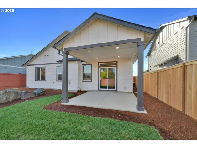 a view of a backyard with plants and a patio