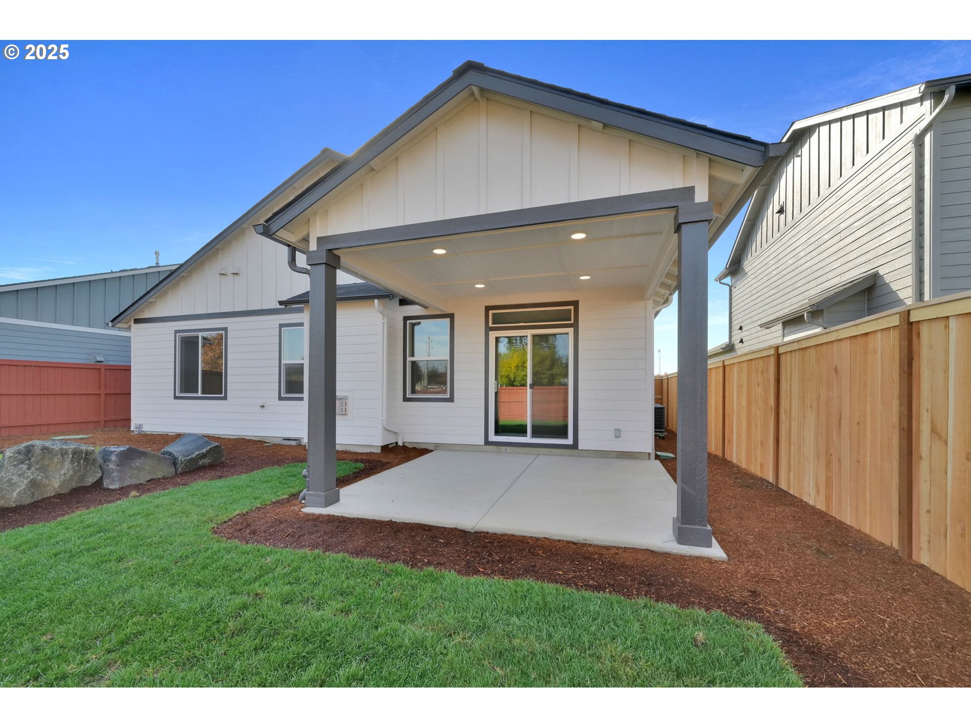 5645 Magnificence Way Eugene, OR 97402 - Photo 30 of 38 a view of a backyard with plants and a patio