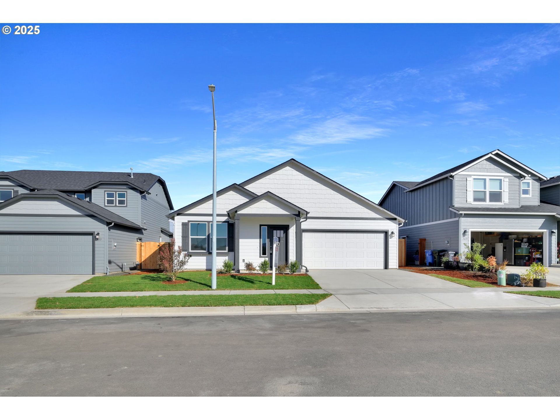 5645 Magnificence Way Eugene, OR 97402 - Photo 32 of 38 a view of a big house with a big yard and large trees