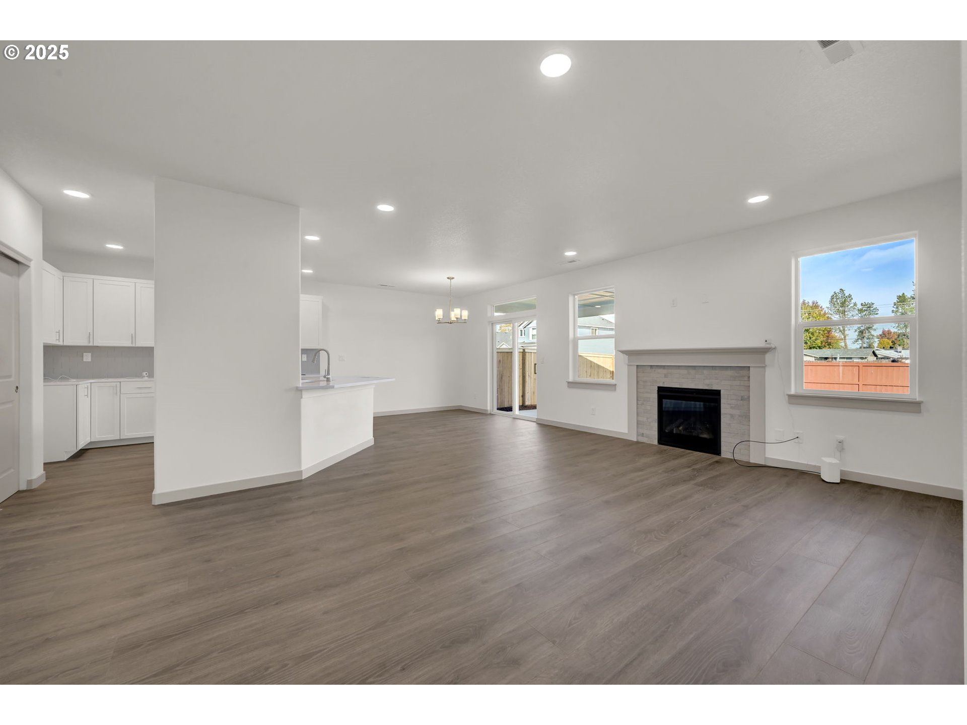 5645 Magnificence Way Eugene, OR 97402 - Photo 38 of 38 a view of an empty room with wooden floor a fireplace