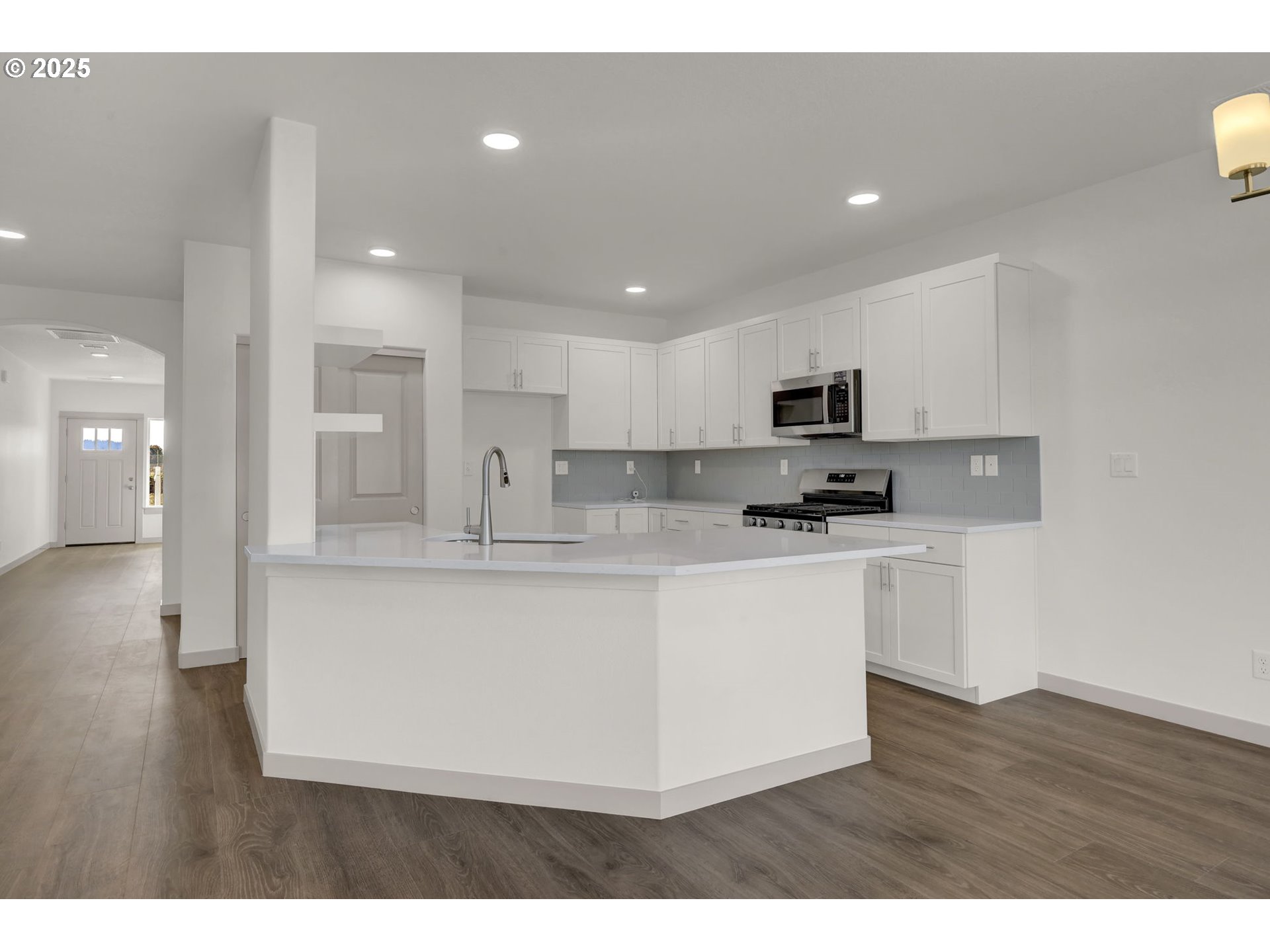 5645 Magnificence Way Eugene, OR 97402 - Photo 5 of 38 a kitchen with stainless steel appliances granite countertop a stove a sink a refrigerator and a microwave