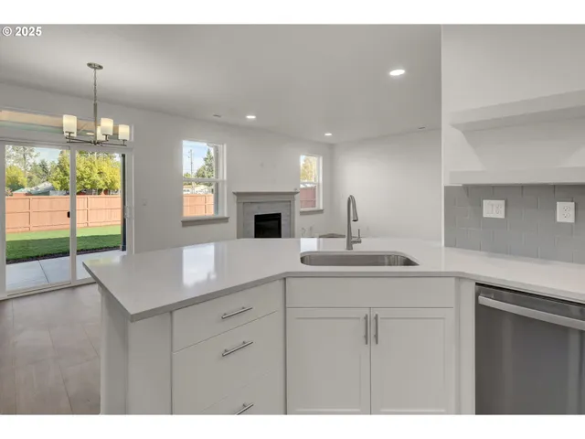 a kitchen with a sink cabinets and window