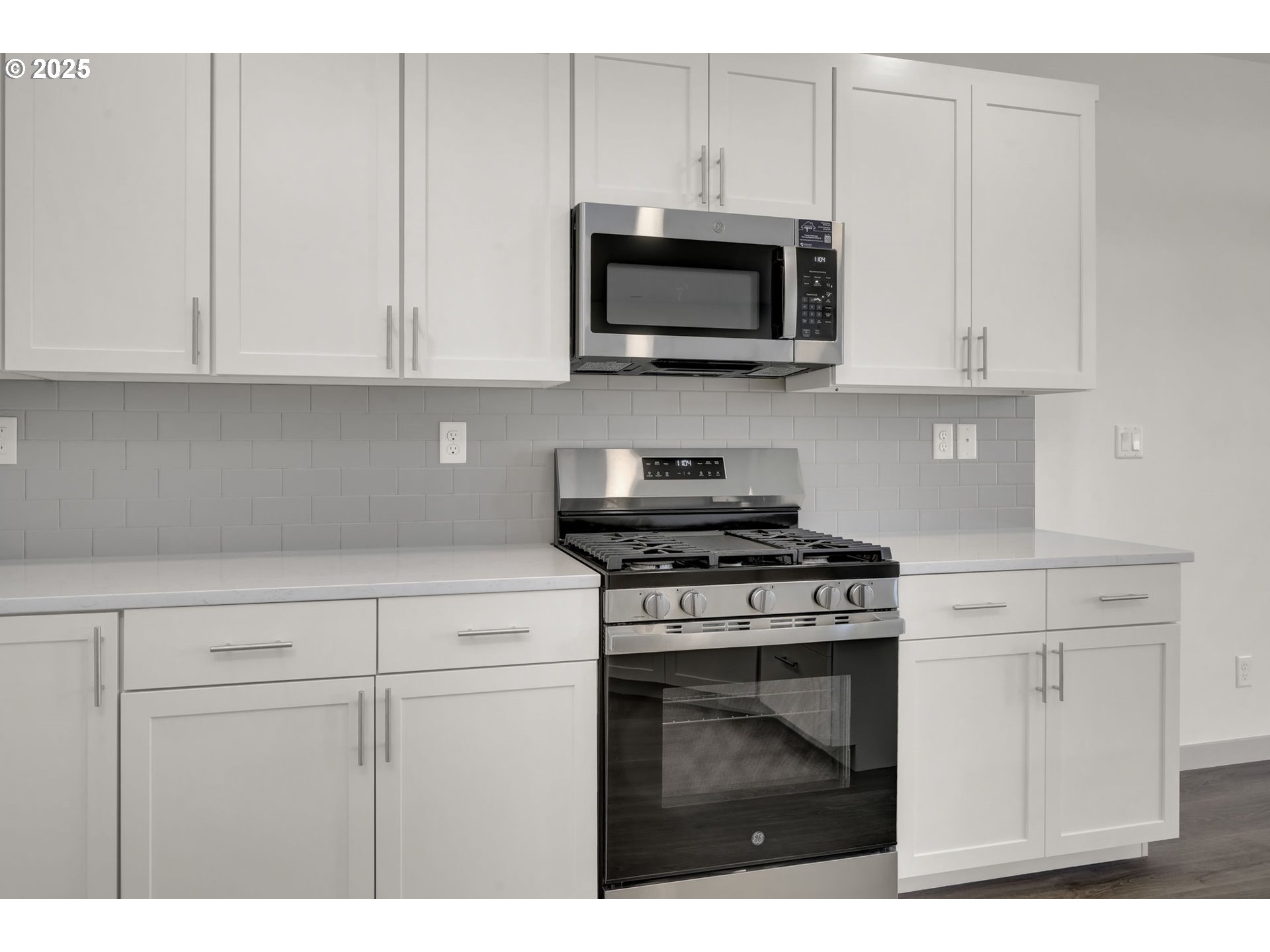 5645 Magnificence Way Eugene, OR 97402 - Photo 9 of 38 a kitchen with white cabinets and stainless steel appliances